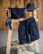 Navy shorts styled with bucket hat and hoodie on rack