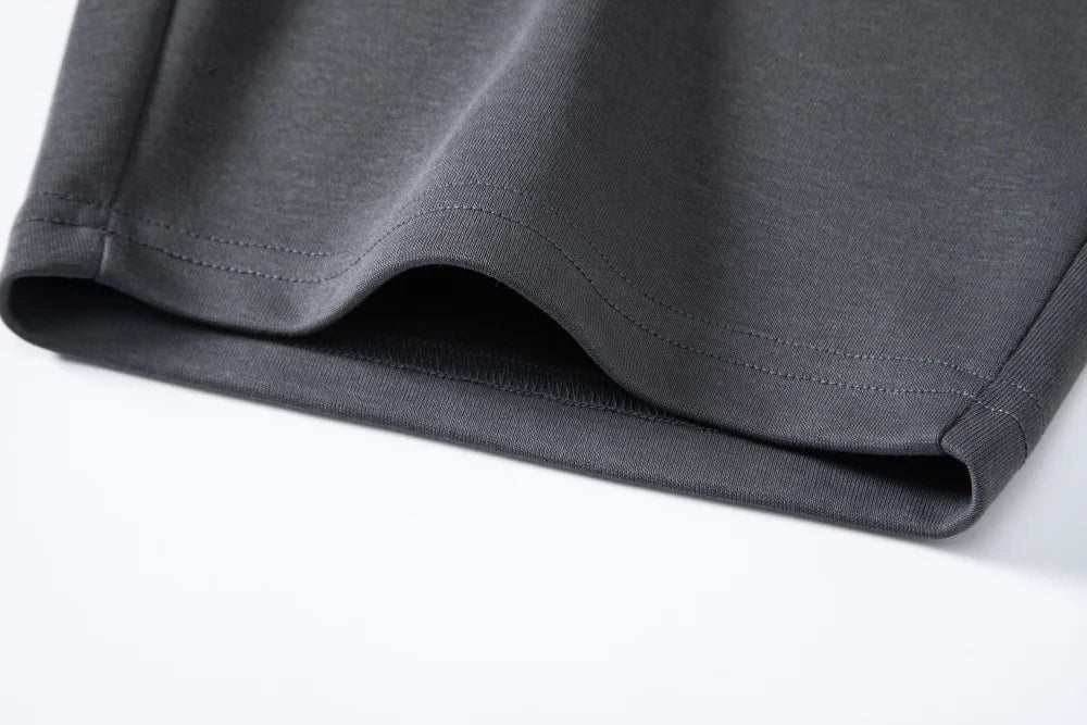 Hem detail of dark gray shorts with small side split
