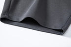 Hem detail of dark gray shorts with small side split