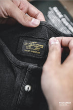 Close-up of the washed black henley's woven interior label