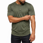 Man wearing the army green everyday henley with dark jeans