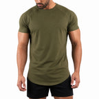 Man wearing the army green athletic gym tee with black shorts