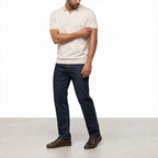 Man wearing the beige open-collar polo with dark jeans