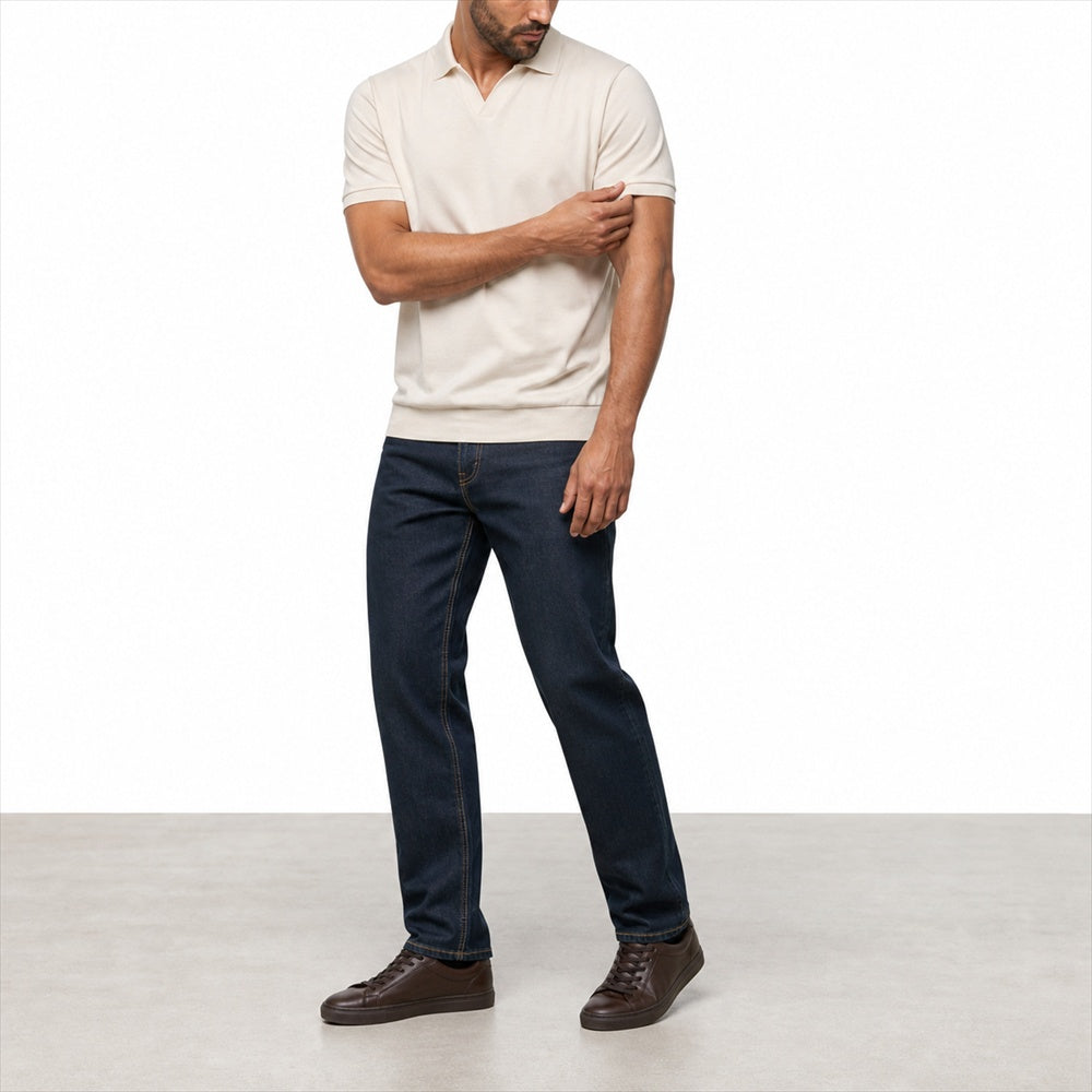 Man wearing the beige open-collar polo with dark jeans