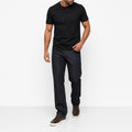 Man wearing the black geometric print t-shirt with dark jeans