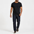 Man wearing the black textured crew neck t-shirt with dark trousers
