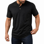 Man wearing the black everyday henley with dark jeans