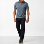 Man wearing the blue open-collar polo with dark jeans