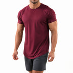 Man wearing the burgundy athletic gym tee with grey shorts