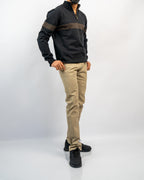 MANLY men's black half-zip knit pullover with tan jacquard chest stripe, worn with khaki tapered trousers