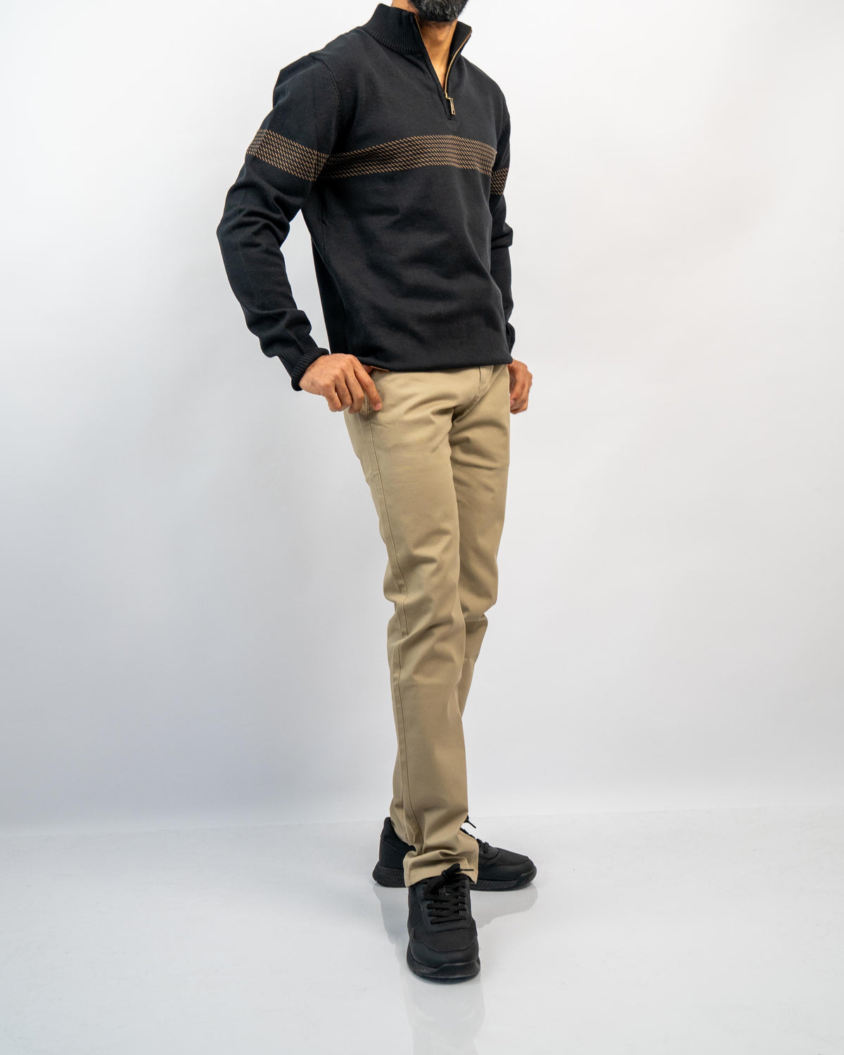 MANLY men's black half-zip knit pullover with tan jacquard chest stripe, worn with khaki tapered trousers