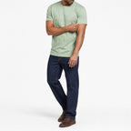 Man wearing the green geometric print t-shirt with dark jeans