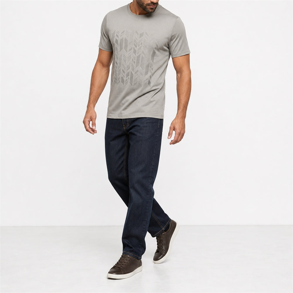 Man wearing the khaki geometric print t-shirt with dark jeans