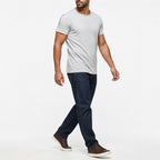 Man wearing the light gray textured crew neck t-shirt with dark trousers