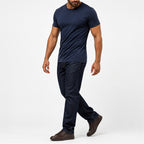 Man wearing the navy blue textured crew neck t-shirt with dark trousers