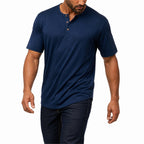 Man wearing the navy blue everyday henley with dark jeans