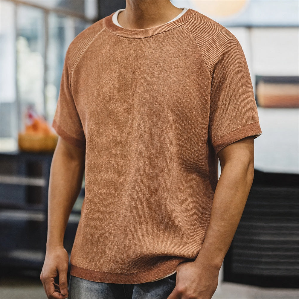Man wearing the marled terracotta knitted tee with jeans, front view