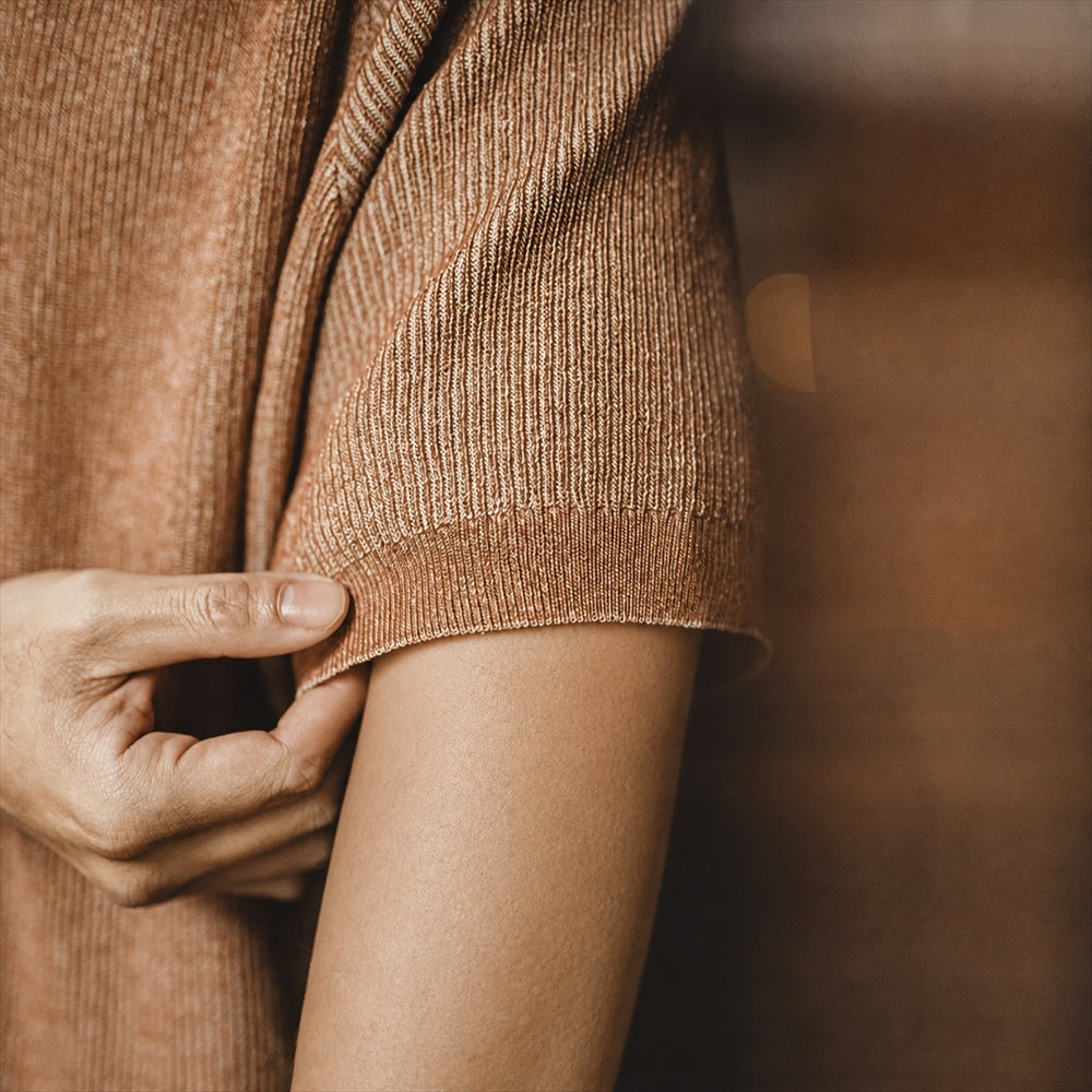 Close-up of the knitted tee's ribbed sleeve cuff