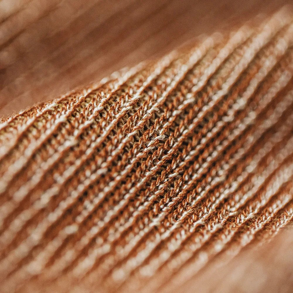 Macro of the marled terracotta yarn showing orange and cream fibers