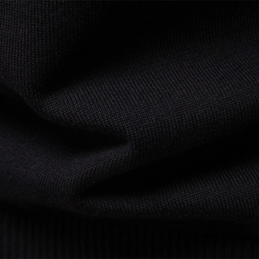 Close-up of the fine knit texture on the men's black half-zip pullover