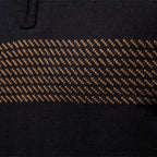 Close-up of the tan jacquard stripe knitted across the chest of the half-zip pullover