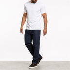 Man wearing the white geometric print t-shirt with dark jeans
