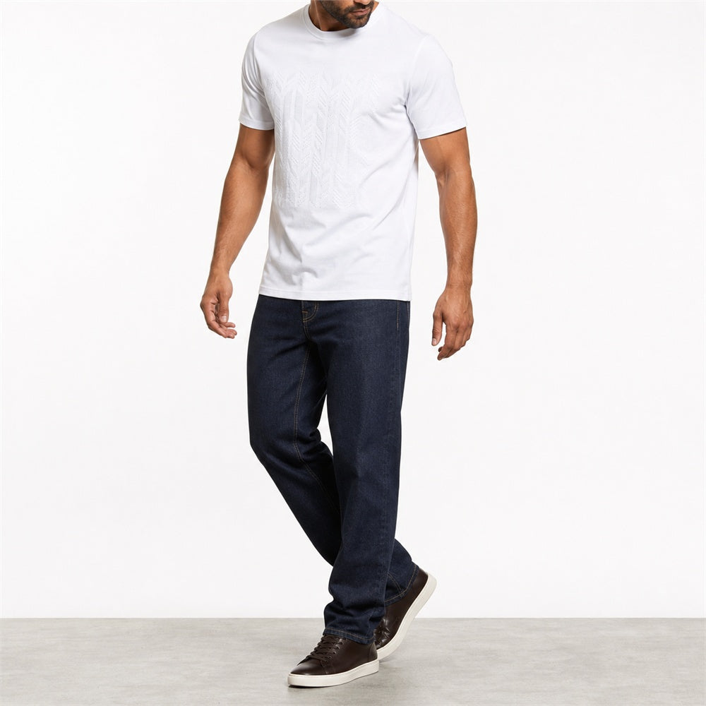 Man wearing the white geometric print t-shirt with dark jeans