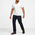 Man wearing the white open-collar polo with dark jeans