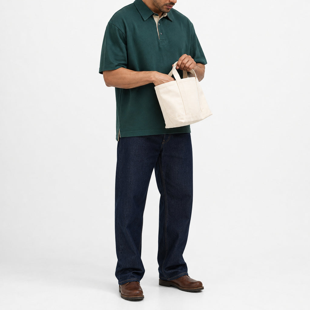 Man wearing the forest green retro polo with navy trousers, full view