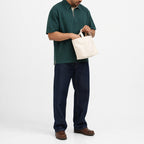 Man wearing the forest green retro polo with navy trousers, full view