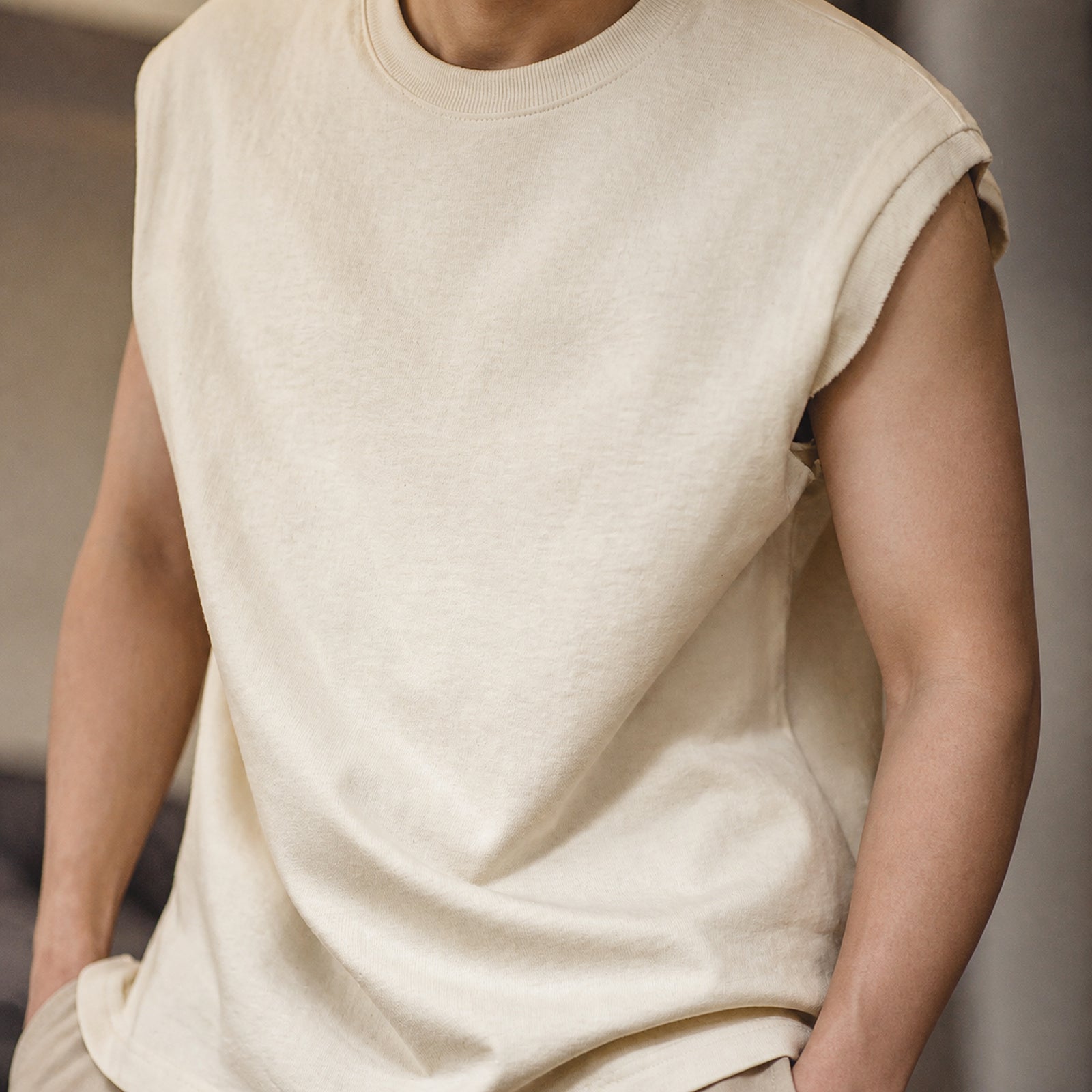 Close-up of the beige knit shoulder vest's cap shoulder and torso