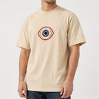 Man in the beige guardian eye embroidered t-shirt, front view