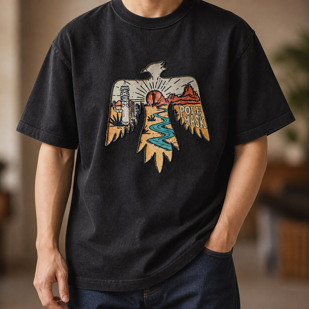Man wearing the washed black thunderbird tee with dark jeans