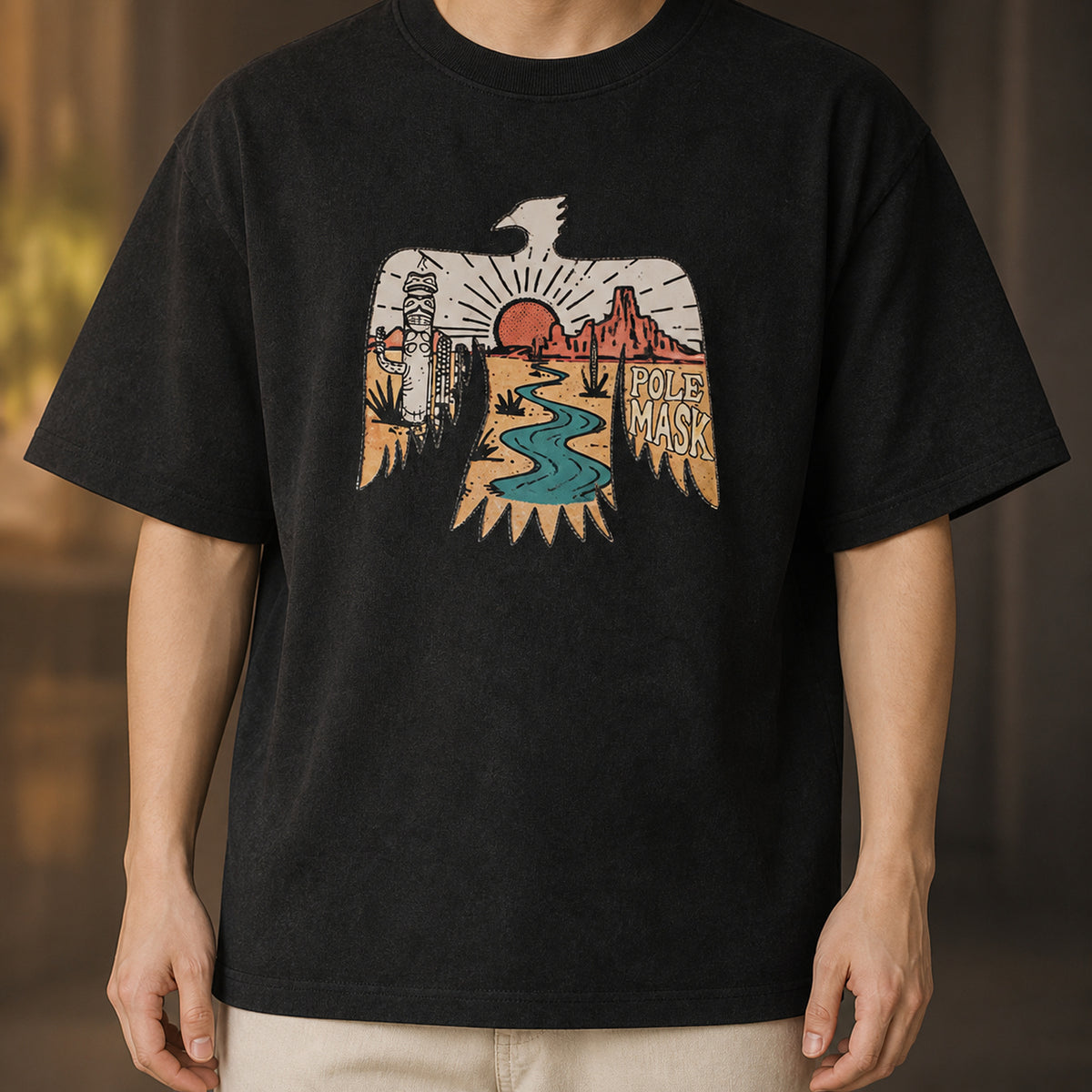 Man in the washed black thunderbird tee with cream trousers