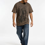 Man wearing the coffee chief portrait tee with blue jeans, full view