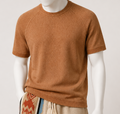Close-up of the marled terracotta knitted tee on a mannequin, crew neck and raglan sleeve seams visible