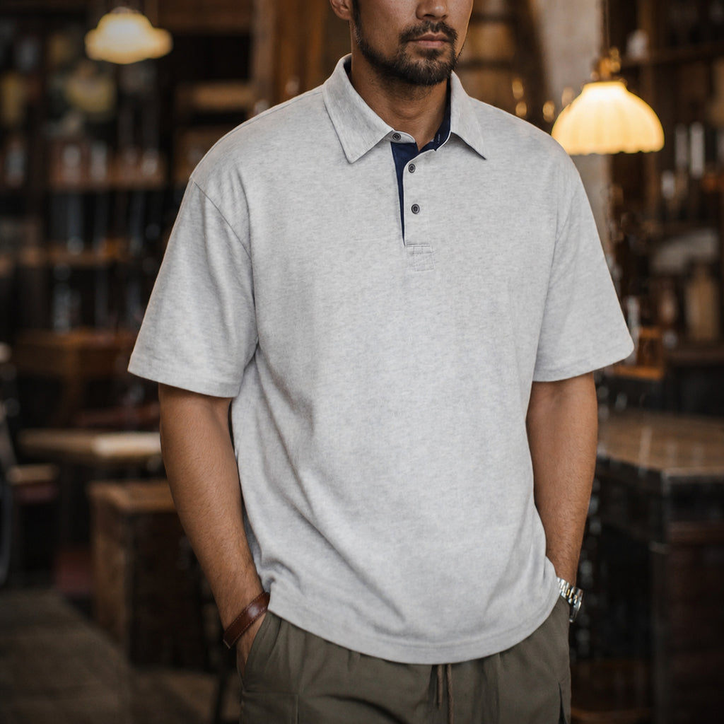 Man wearing the heather grey retro polo with olive trousers