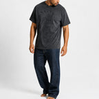 Man wearing the gray chief portrait tee with dark trousers, full view