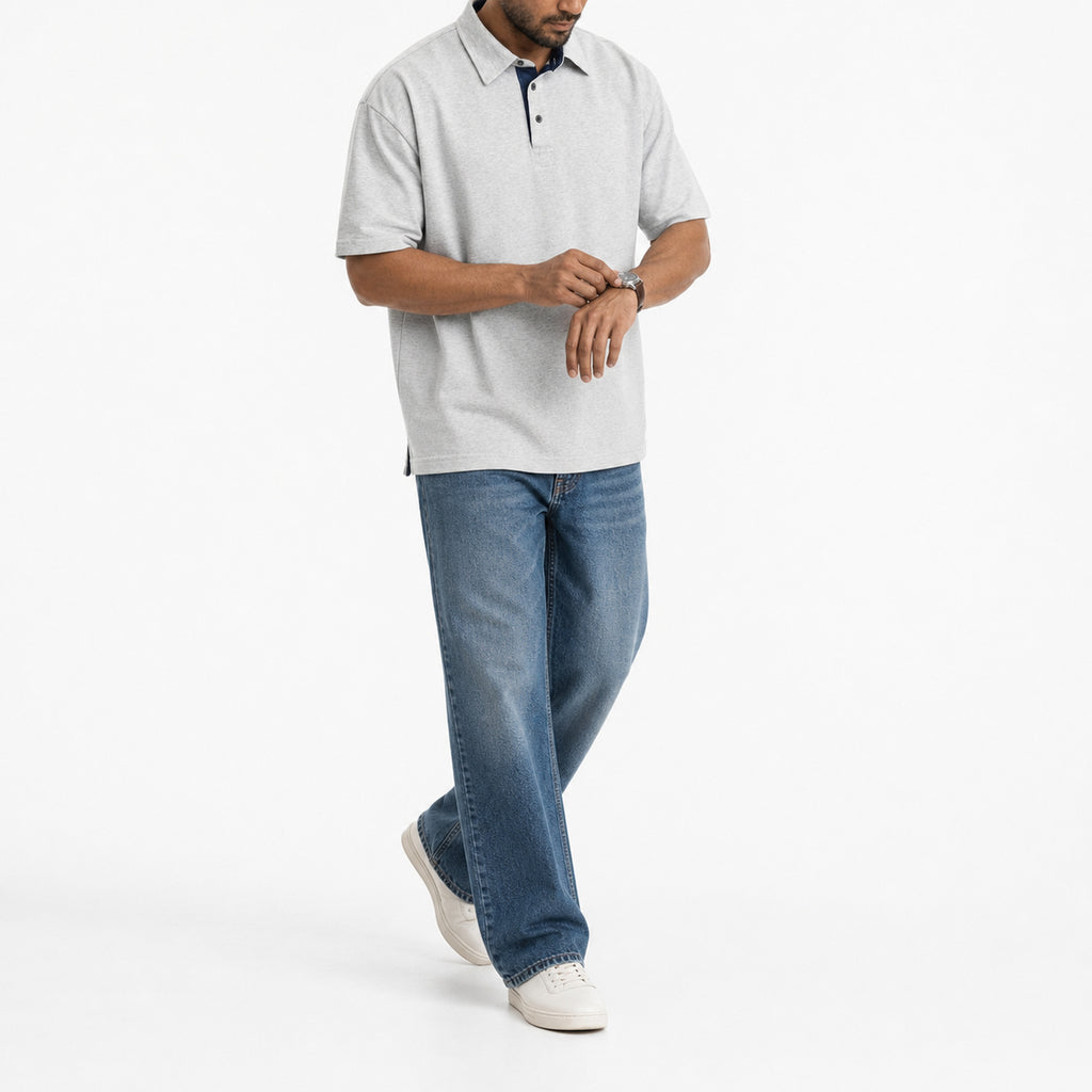 Man wearing the heather grey retro polo with blue jeans, full view