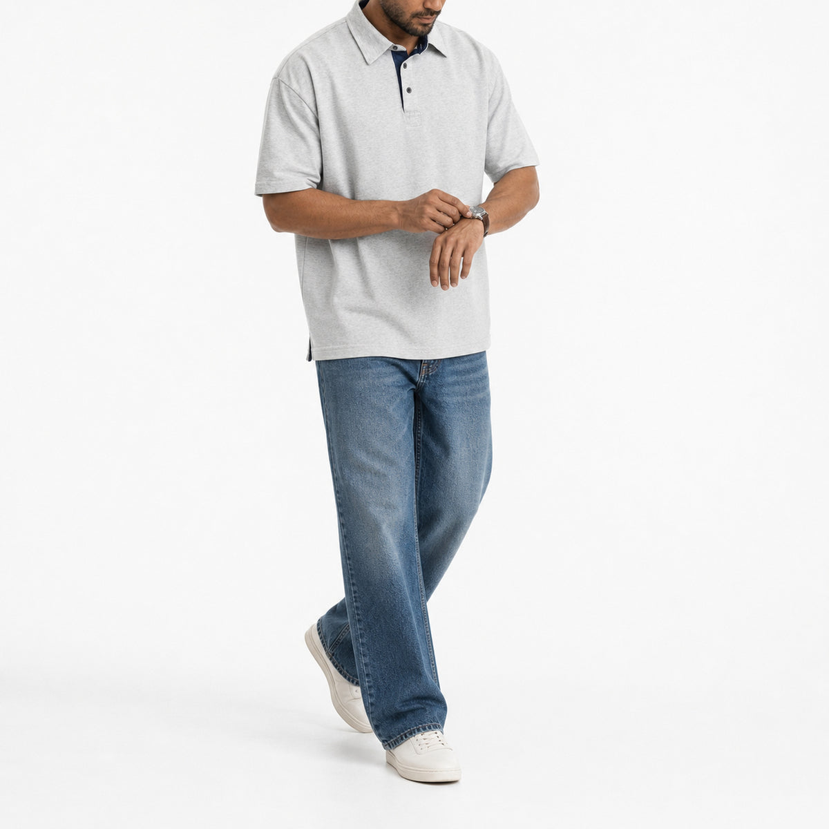 Man wearing the heather grey retro polo with blue jeans, full view