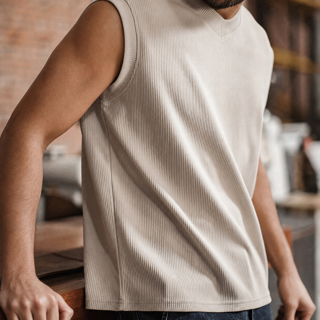 Man wearing the khaki ribbed v-neck tank, side view