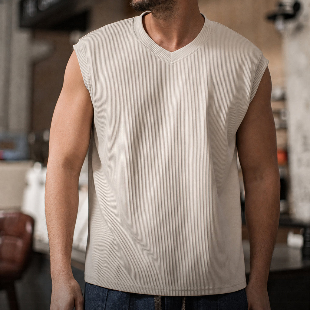 Man in the khaki ribbed v-neck tank with blue jeans, front view