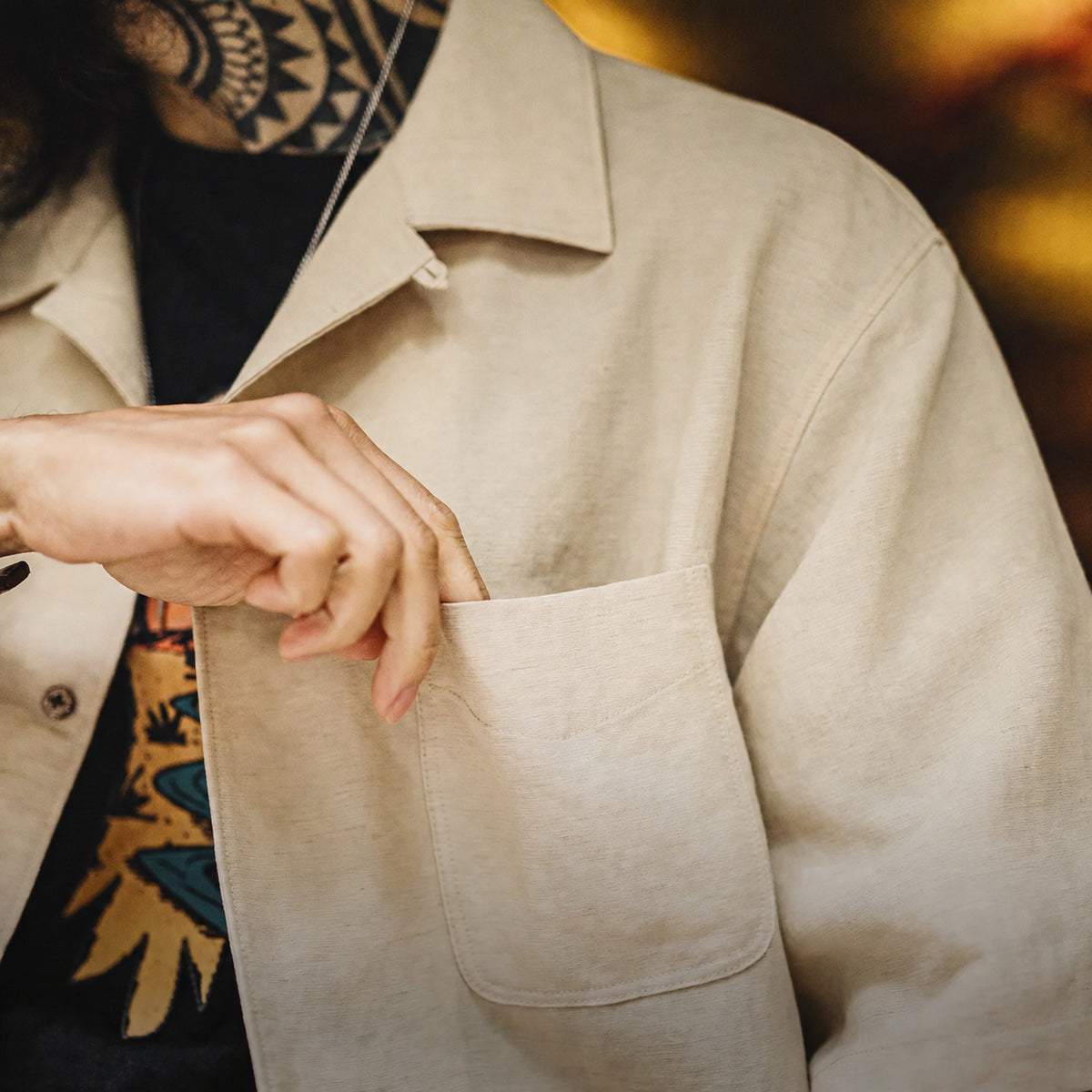 Close-up of the khaki lyocell shirt's textured weave and patch pocket
