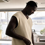 Man wearing the khaki ribbed v-neck tank, rib texture visible