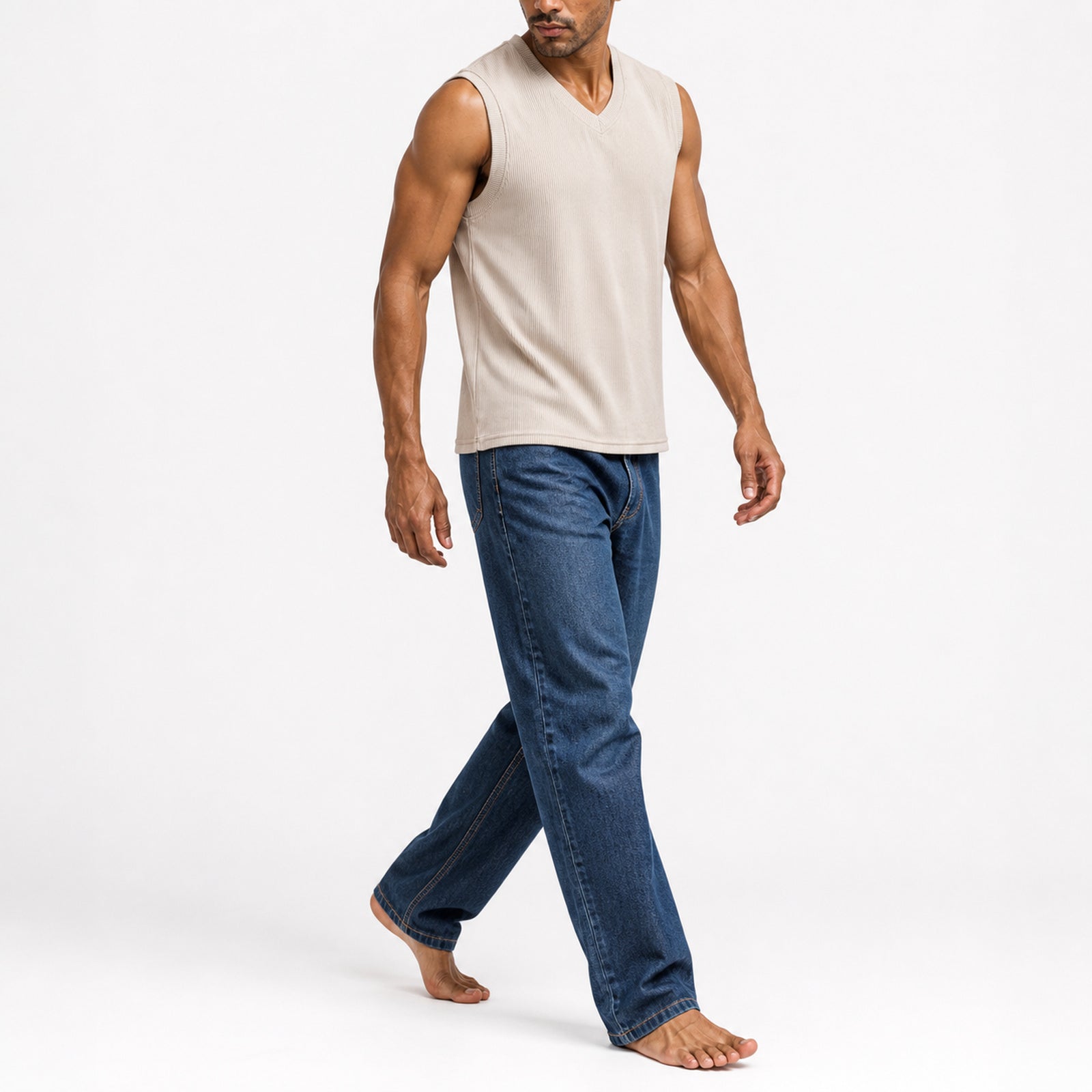 Man walking in the khaki ribbed v-neck tank with jeans, full view