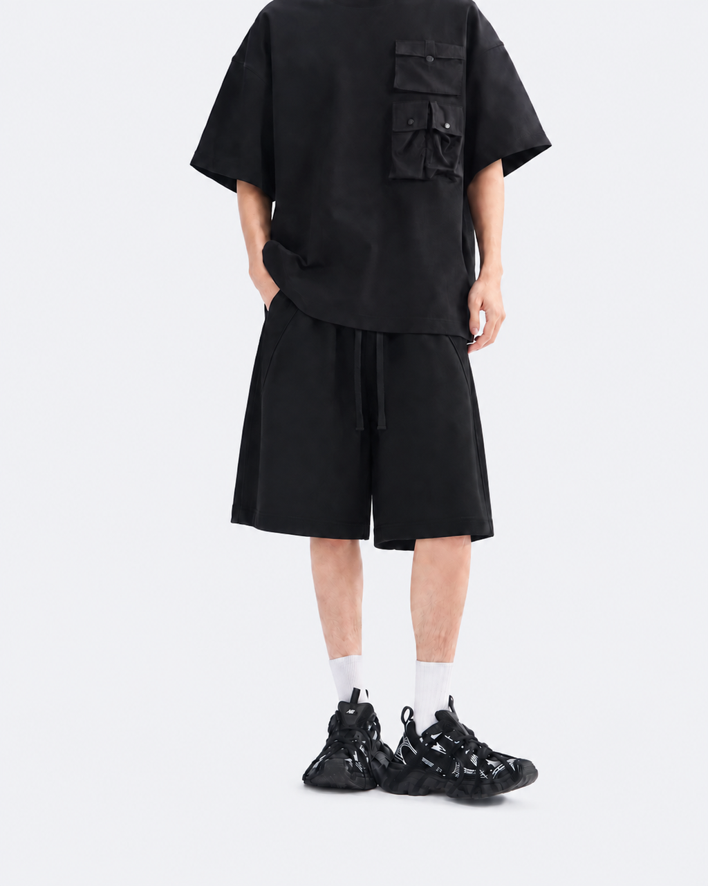 Black oversized snap-pocket T-shirt and wide-leg shorts set, front view