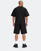 Kuwaiti model wearing the black oversized T-shirt and wide-leg shorts set, back view