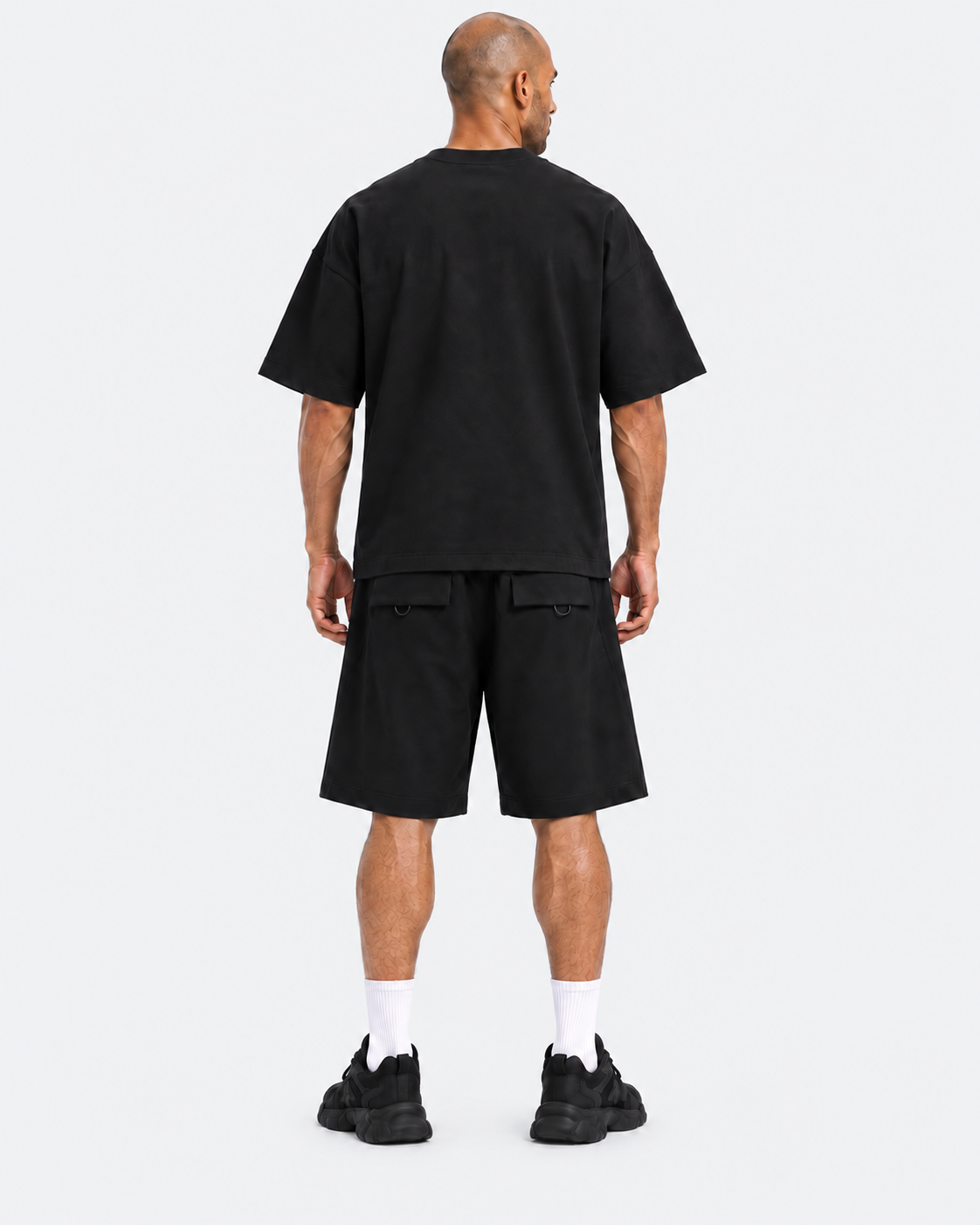 Kuwaiti model wearing the black oversized T-shirt and wide-leg shorts set, back view