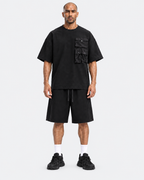 Kuwaiti model wearing the black oversized T-shirt and wide-leg shorts set, front view