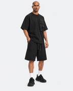 Kuwaiti model wearing the black oversized T-shirt and wide-leg shorts set, three-quarter view